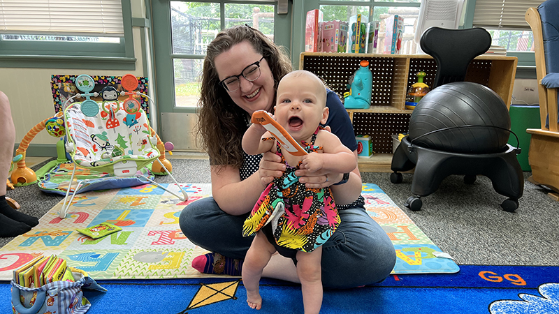 A Teacher works with an infant at the Erwin Child & Family Center