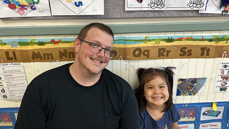 A Teacher Aide works with children at the Erwin Child & Family Center