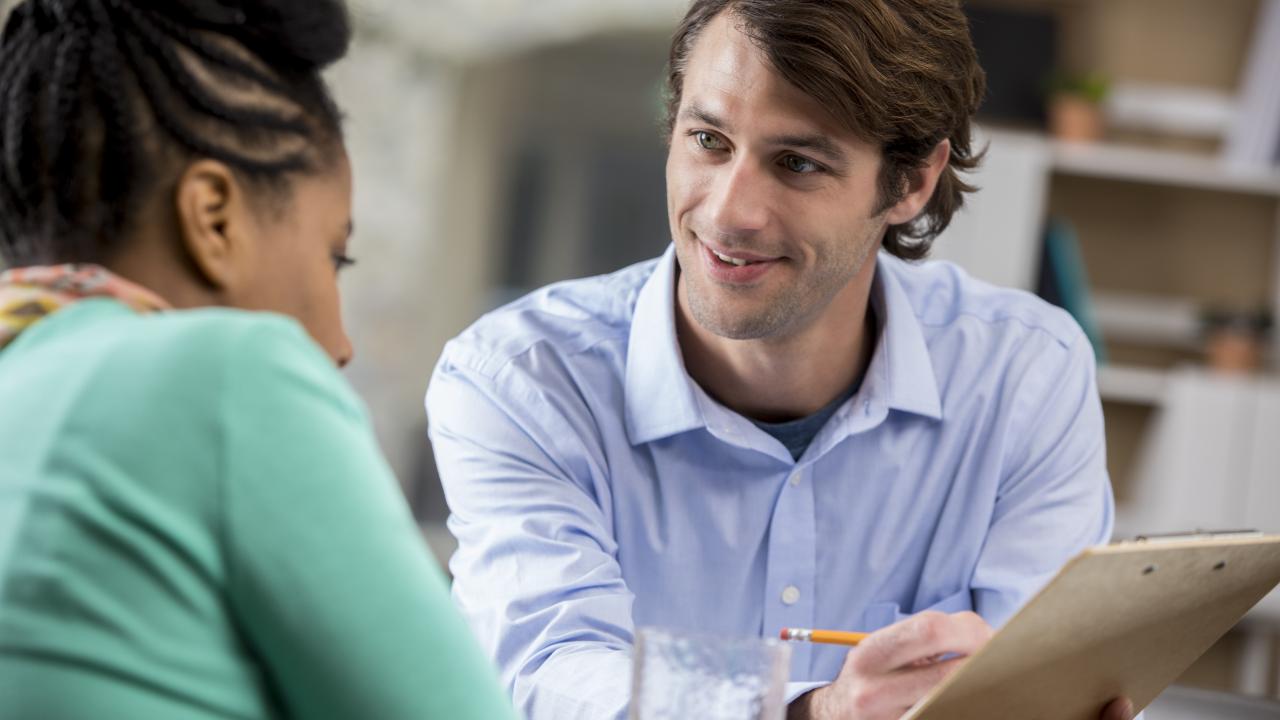 Friendly man counseling a woman