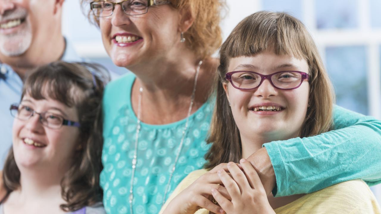 Happy family with two daughters that have Down syndrome