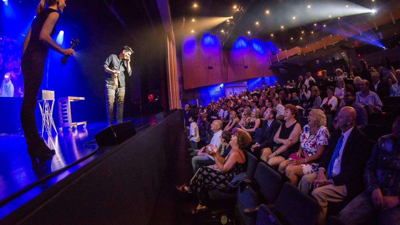 A group of people watching a magic show