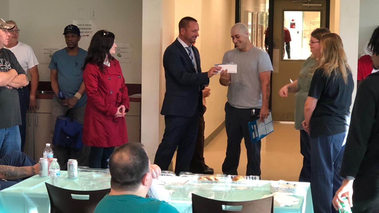Employees at Pladis Global handing their donation to Pathways Inc President and CEO Joe Cevette