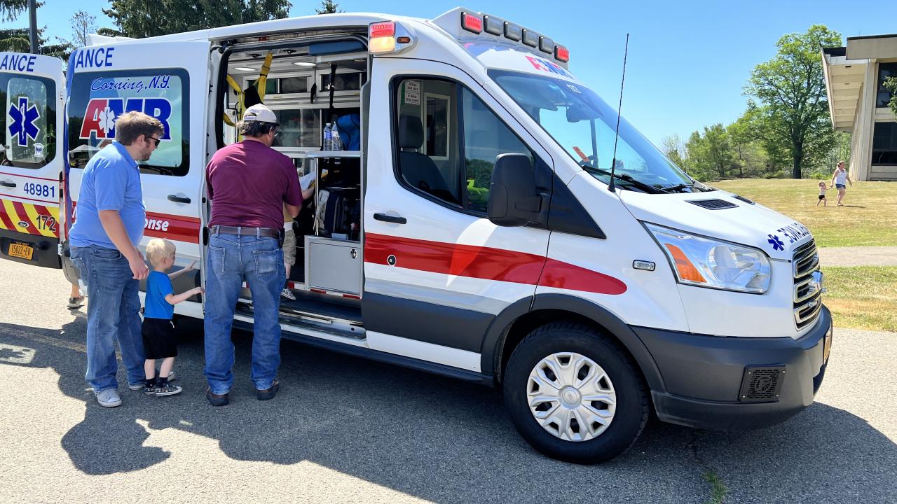people looking inside an ambulance