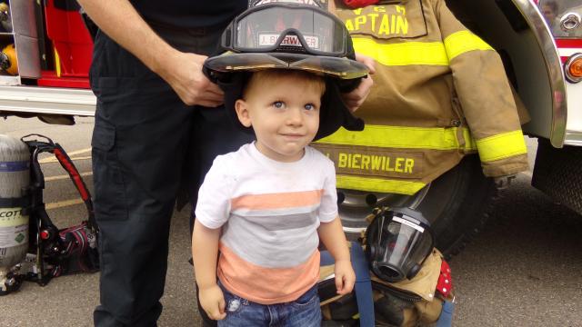 Boy wearing a firemans helmet