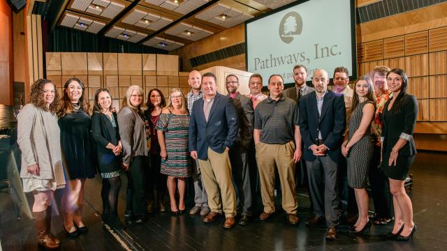 A group of nicely dressed people at the Annual Fundraiser