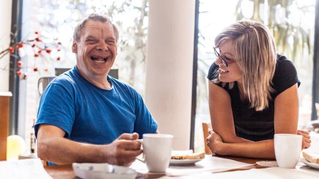 Happy Man Sitting at the Table