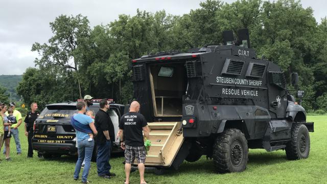 People standing in front of the Steuben County Rescue Vehicle