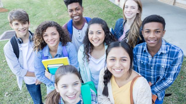 Group of diverse teens standing outside