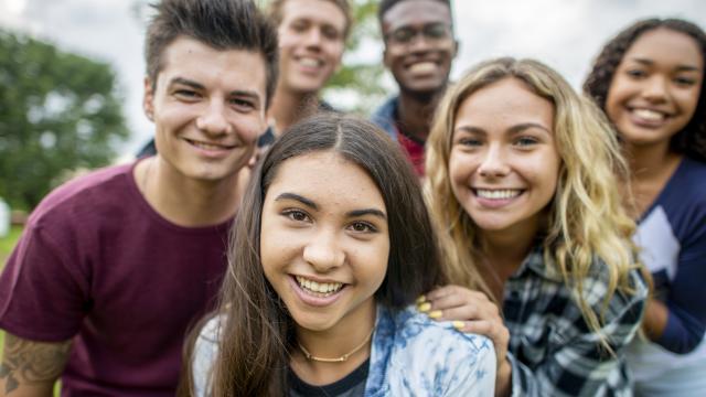 Diverse group of young adults standing outside