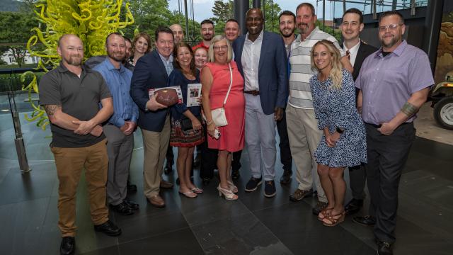 Wegmans staff standing with Bruce Smith