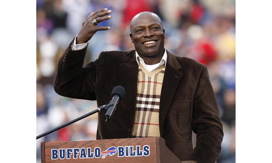 Bruce Smith former Buffalo Bills Defensive Tackle and Pro Football Hall of Famer standing at a podium showing his ring