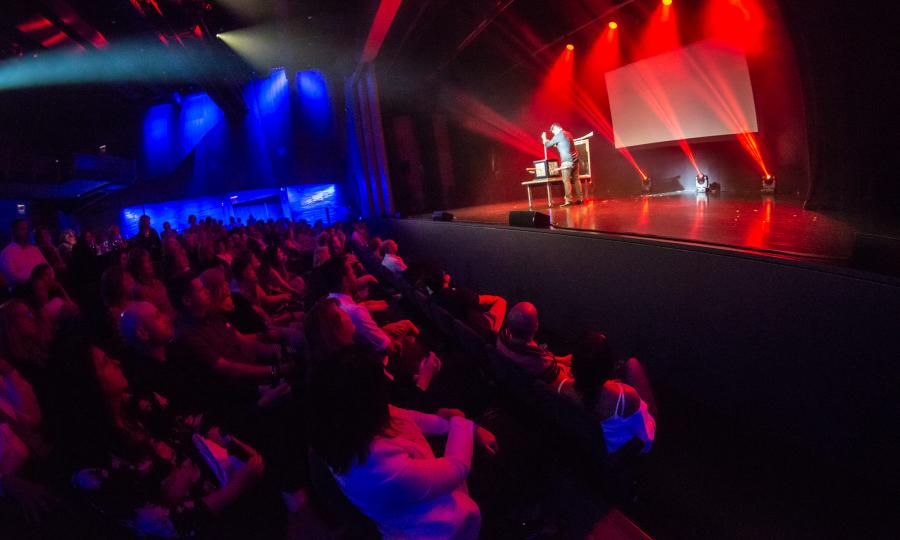 Illusionist Jason Bishop performs in front a crowd at the Corning Museum of Glass